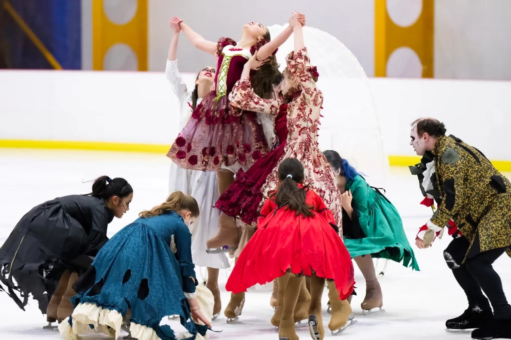 A group of people in costumes on an ice rink.