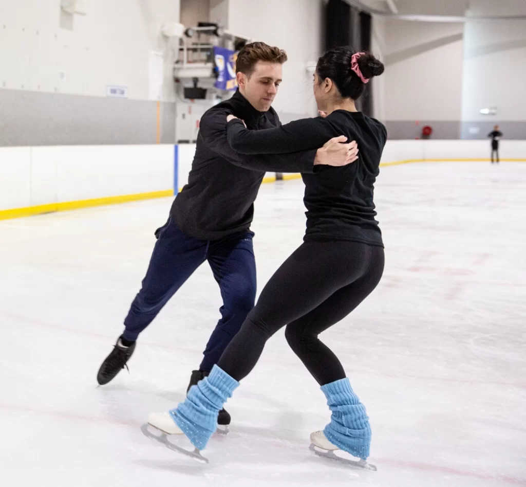 A man and woman on an ice skating rink.